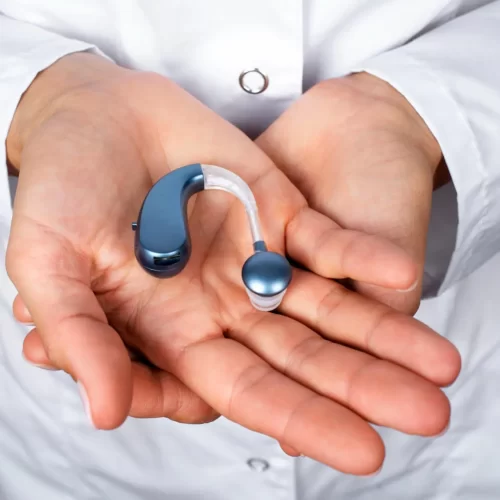 high-angle-hands-holding-hearing-aids (1)